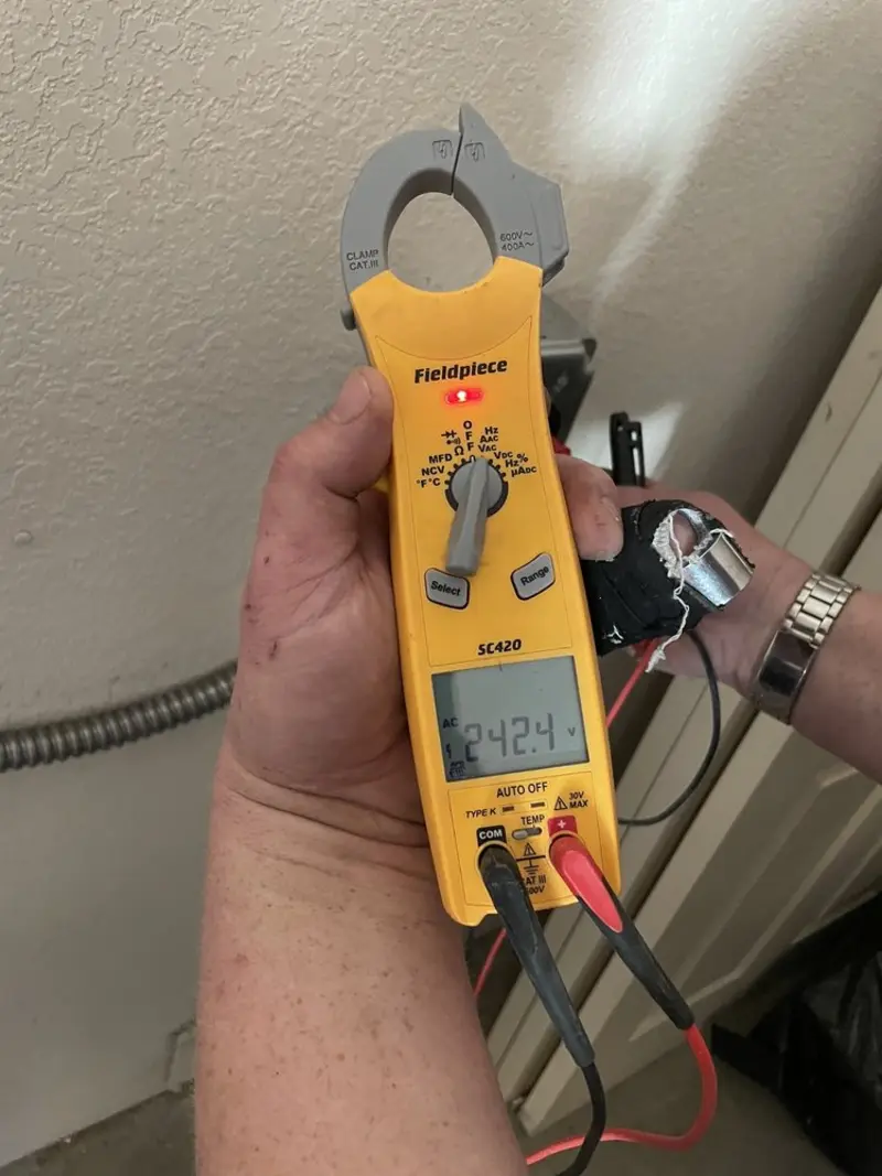 Voltage testing with clamp meter during Outlet Installation in Cameron